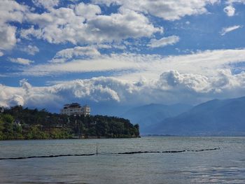 Scenic view of sea and mountains against sky