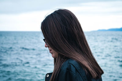 Portrait of woman by sea against sky