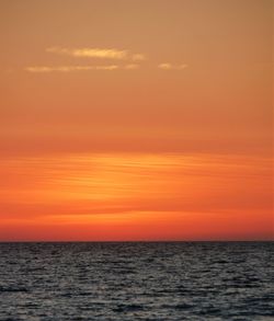 Scenic view of sea against orange sky