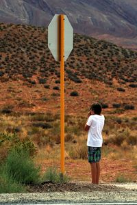 Man standing on land against mountain