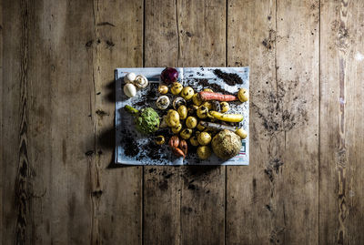 High angle view of artichoke and carrot on wooden table