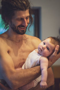 Portrait of shirtless baby boy at home