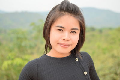 Portrait of young woman standing on observation point 