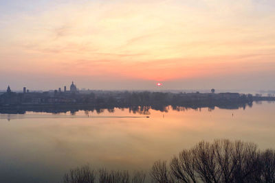 Scenic view of river against sky during sunset