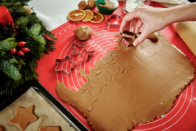Process of woman making gingerbread cookies at home