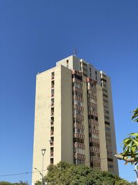 Low angle view of building against clear blue sky