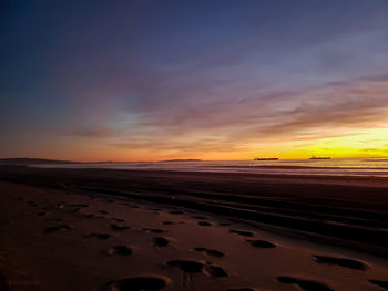 Scenic view of desert against sky during sunset