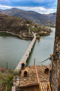 High angle view of bridge over river against mountains