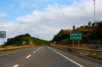 Road sign against sky