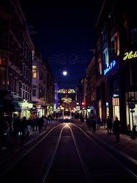 Illuminated city street at night