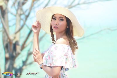 Portrait of beautiful young woman wearing hat