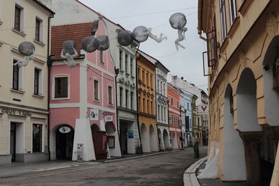 Low angle view of street amidst buildings in city