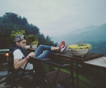 Side view of a man sitting on food