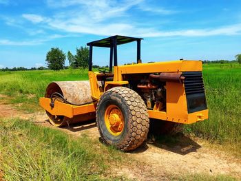 Tractor on field against sky