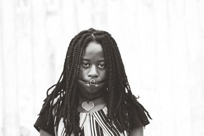 Portrait of girl against wall