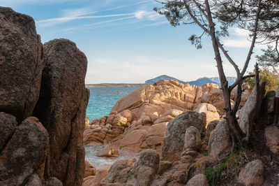 Rock formations by sea against sky