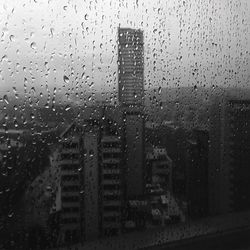 Raindrops on glass window of rainy season