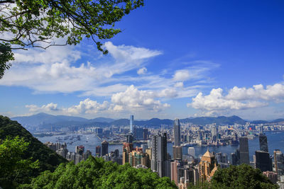 Modern buildings in city against cloudy sky