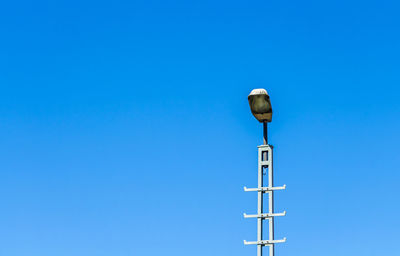 Low angle view of street light against clear blue sky