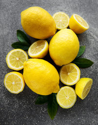 Fresh ripe lemons on dark concrete background