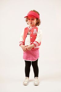 Portrait of happy girl standing against white background