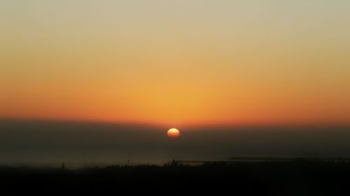 Silhouette landscape against romantic sky at sunset