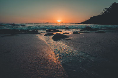 Scenic view of sea against clear sky during sunset