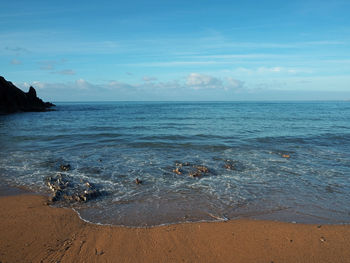 Scenic view of sea against cloudy sky