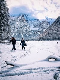 People standing on snow covered landscape