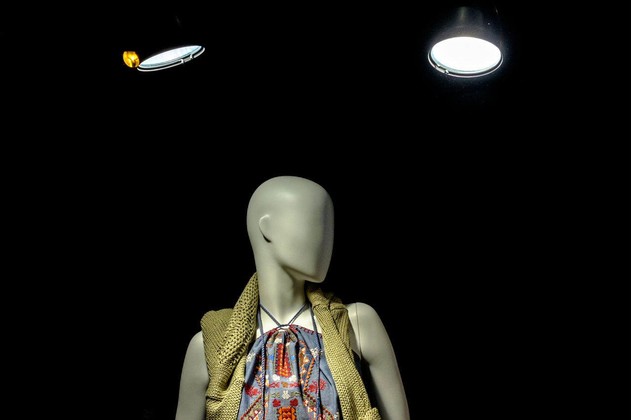 human representation, mannequin, female likeness, retail display, no people, male likeness, retail, store, doll, illuminated, indoors, studio shot, black background, close-up, day