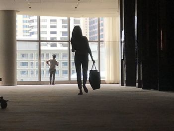 Rear view of silhouette people walking in corridor