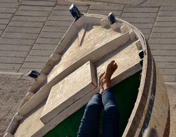 Low section of person relaxing on boat
