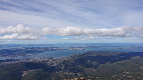 High angle view of sea and mountains against sky