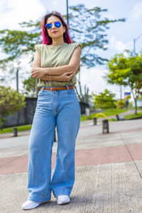 Portrait of young woman wearing sunglasses standing outdoors