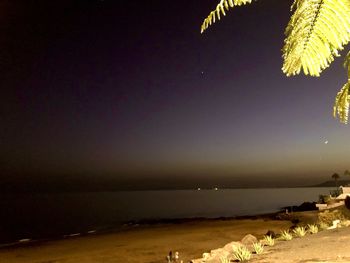 Scenic view of sea against clear sky at night