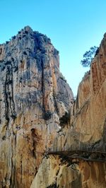 Low angle view of rocky mountain against sky