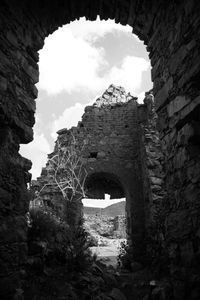 Archway of old building against sky