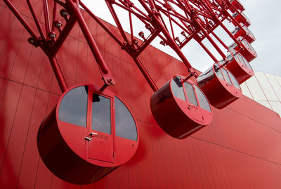 Low angle view of lighting equipment hanging against ceiling