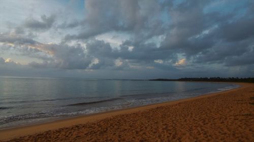 Scenic view of sea against storm clouds