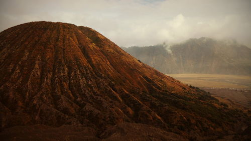 Scenic view of arid landscape against sky