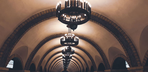 Low angle view of illuminated chandelier in building