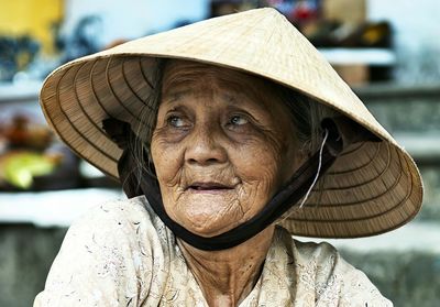 Close-up of senior woman wearing hat looking away