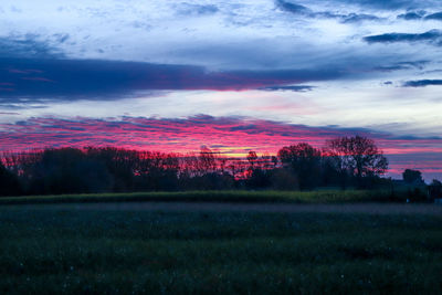 Scenic view of field against sky during sunset