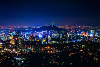 High angle view of illuminated buildings against sky at night