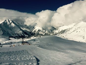 Scenic view of snow covered mountains against sky