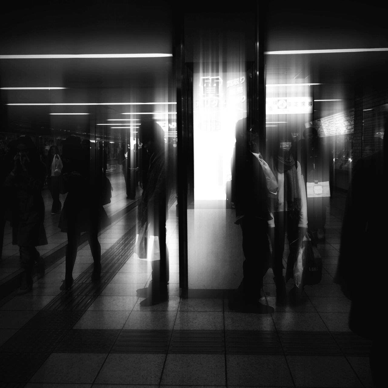 indoors, public transportation, railroad station, illuminated, railroad station platform, men, transportation, person, subway station, passenger, walking, lifestyles, rail transportation, subway, travel, city life, large group of people, waiting, medium group of people