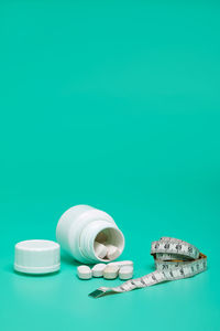 Close-up of bottle on table against blue background