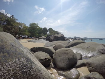 Rocks on beach against sky