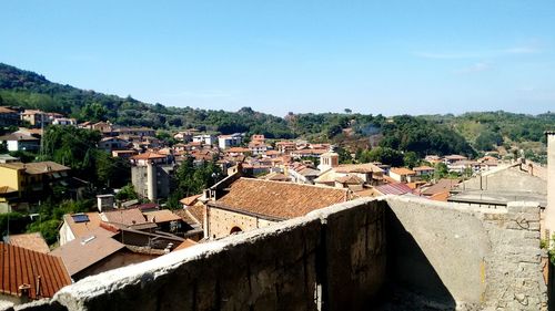 High angle view of houses in town against clear sky