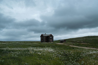 Built structure on field against sky